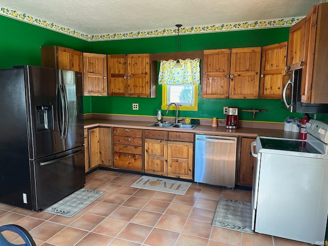 kitchen with appliances with stainless steel finishes, light tile patterned flooring, a textured ceiling, decorative light fixtures, and sink