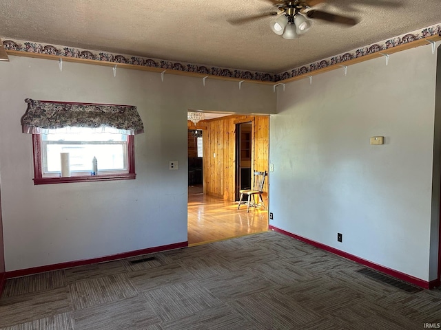 spare room with wood-type flooring, ceiling fan, and a textured ceiling