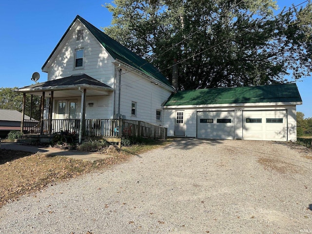 view of front of property featuring covered porch and a garage