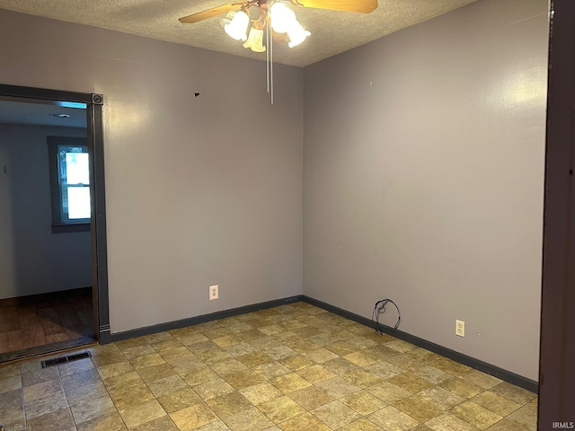 empty room featuring a textured ceiling and ceiling fan