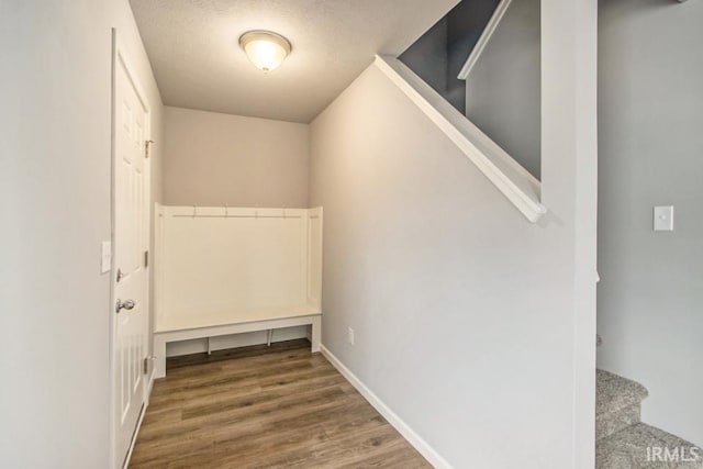 laundry area with a textured ceiling and hardwood / wood-style flooring