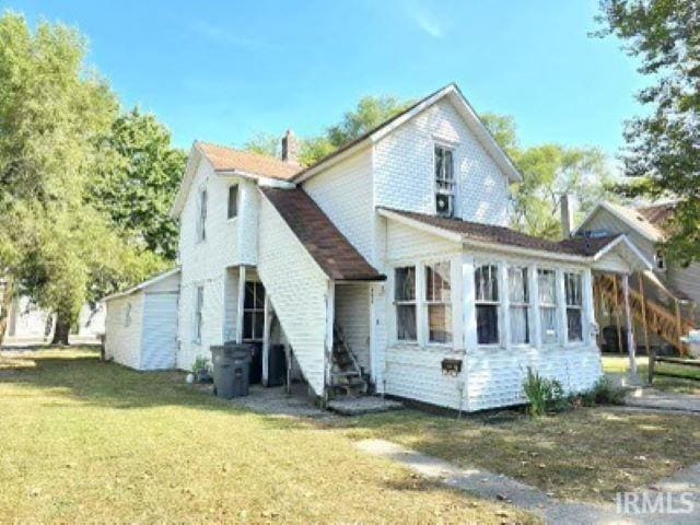 back of house with a lawn