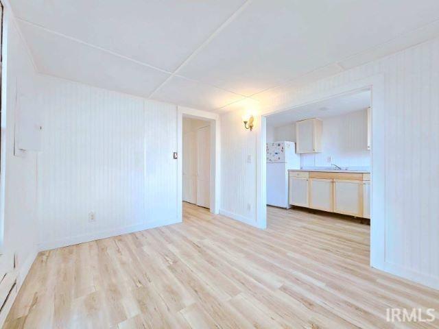 unfurnished living room with light hardwood / wood-style flooring