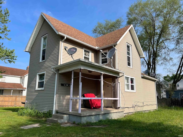 back of house featuring a lawn