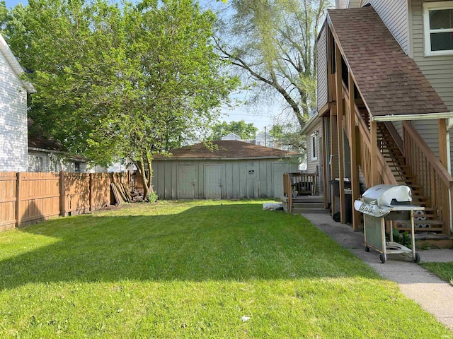 view of yard featuring a deck and a shed