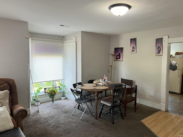 dining area with dark carpet