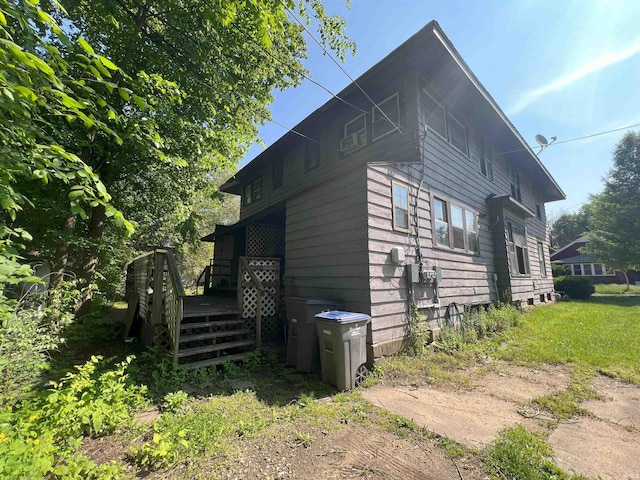 view of side of home featuring a wooden deck