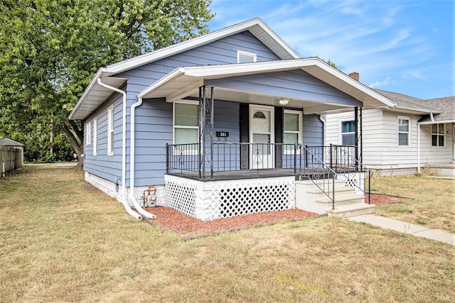 bungalow featuring a front yard and covered porch