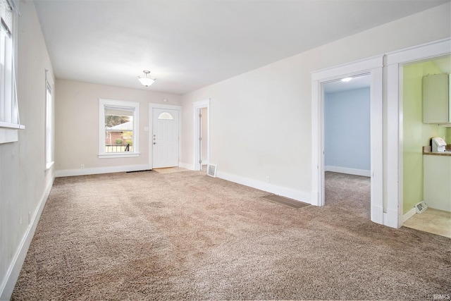 unfurnished living room featuring carpet flooring