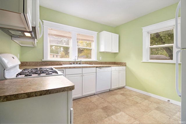 kitchen with white cabinets, sink, and white appliances