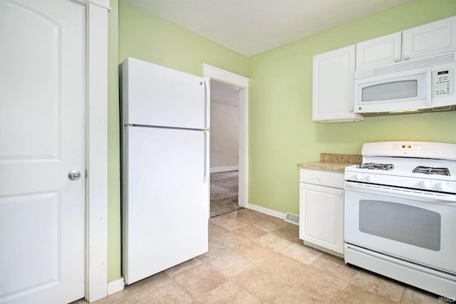 kitchen with white appliances and white cabinetry