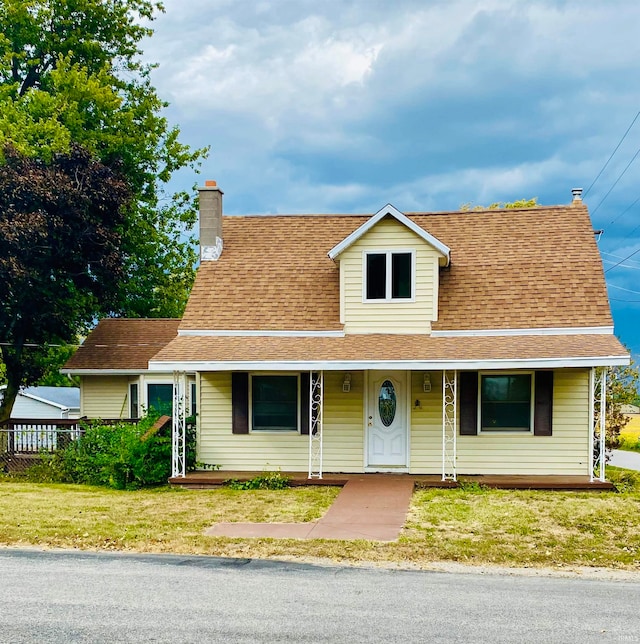 view of front of home featuring a front yard and a porch