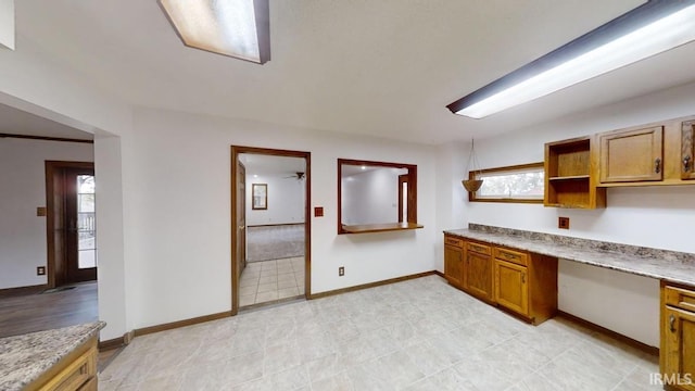 kitchen featuring built in desk and a healthy amount of sunlight