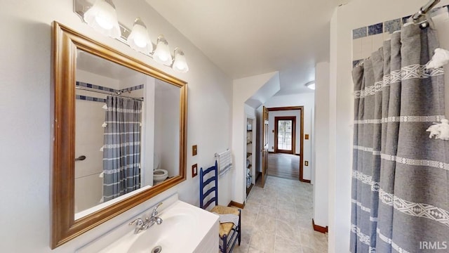 bathroom featuring curtained shower, vanity, and toilet