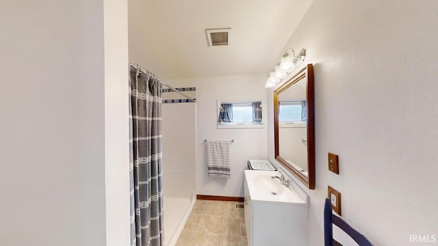 bathroom with tile patterned flooring, vanity, and a shower with shower curtain