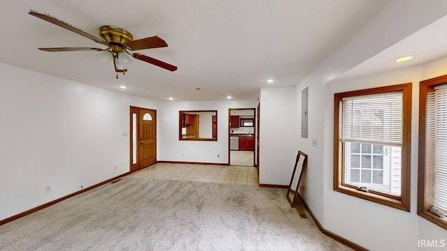 carpeted spare room featuring electric panel and ceiling fan