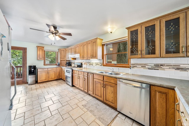 kitchen featuring backsplash, sink, ceiling fan, and stainless steel appliances