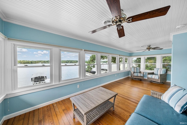 sunroom featuring lofted ceiling, ceiling fan, and plenty of natural light