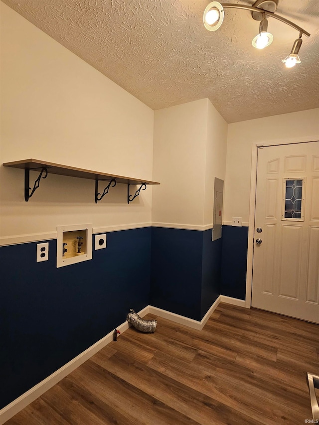 clothes washing area featuring washer hookup, hookup for an electric dryer, a textured ceiling, electric panel, and dark hardwood / wood-style floors