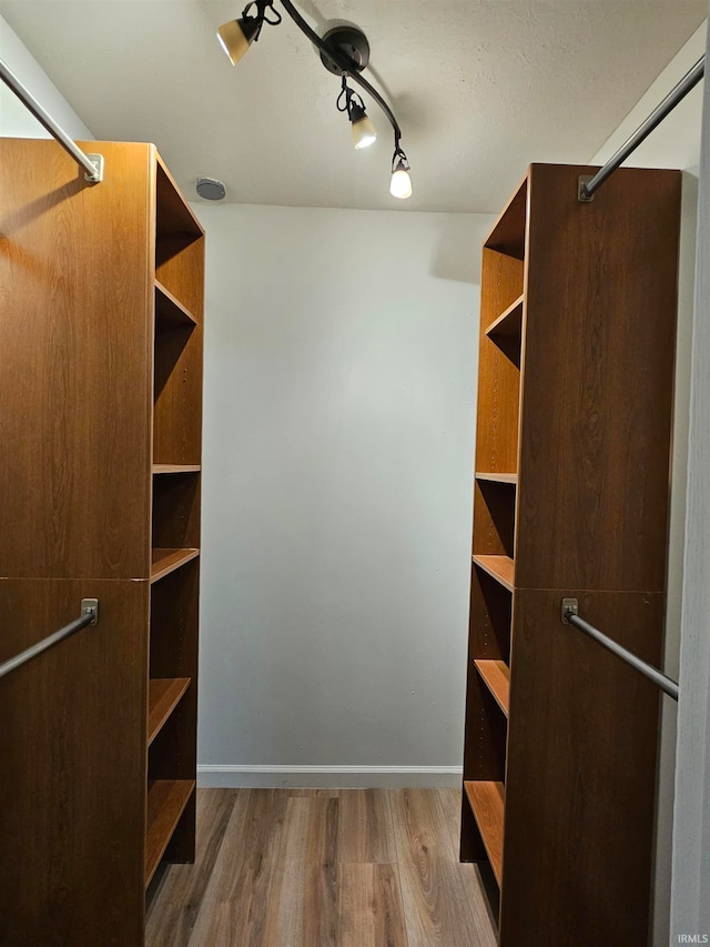 spacious closet featuring hardwood / wood-style flooring