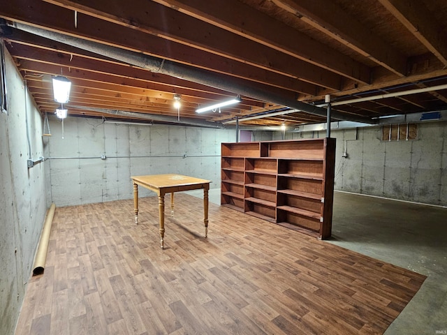 basement featuring hardwood / wood-style floors