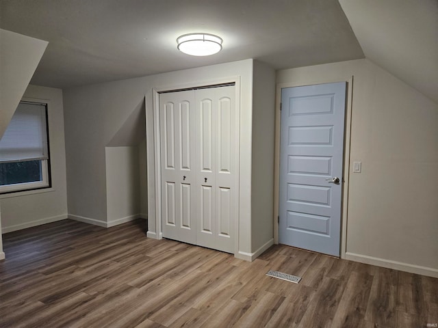 bonus room featuring wood-type flooring and lofted ceiling