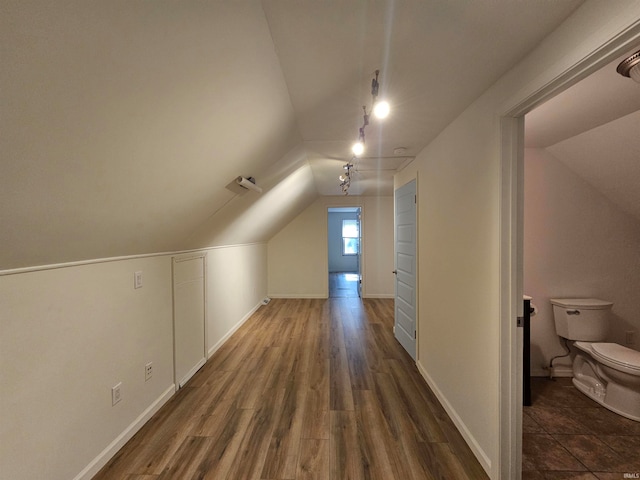 bonus room with lofted ceiling and dark hardwood / wood-style floors