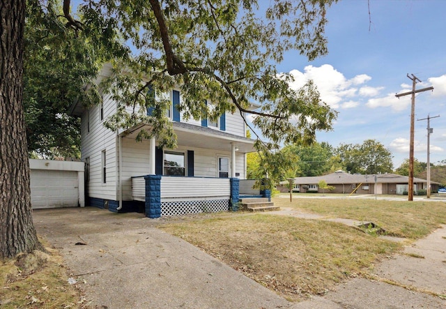 view of front of home featuring a garage, a front lawn, and covered porch