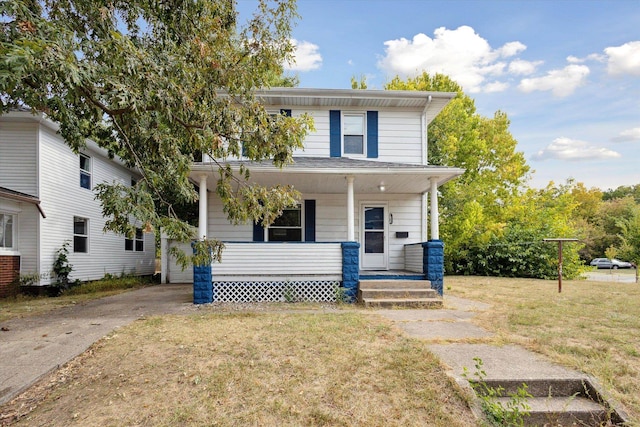 front facade featuring a front lawn and covered porch