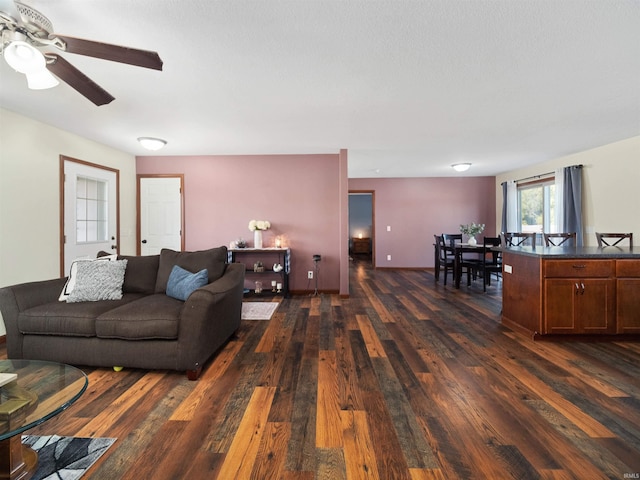 living room with dark hardwood / wood-style floors and ceiling fan