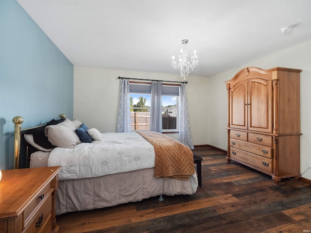 bedroom featuring an inviting chandelier and dark hardwood / wood-style floors