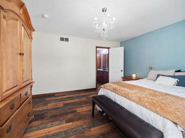 bedroom featuring connected bathroom and dark wood-type flooring