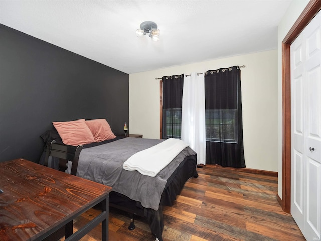 bedroom with a closet and dark wood-type flooring