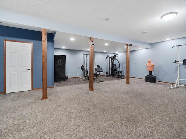 basement featuring a textured ceiling and carpet flooring