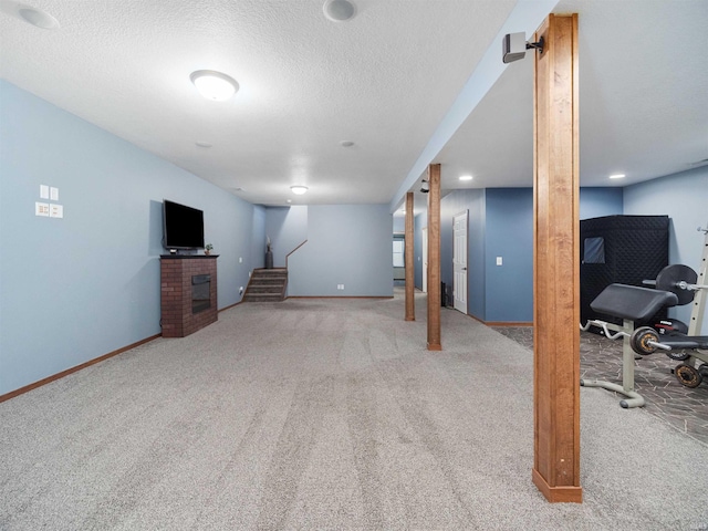 basement featuring a textured ceiling and carpet