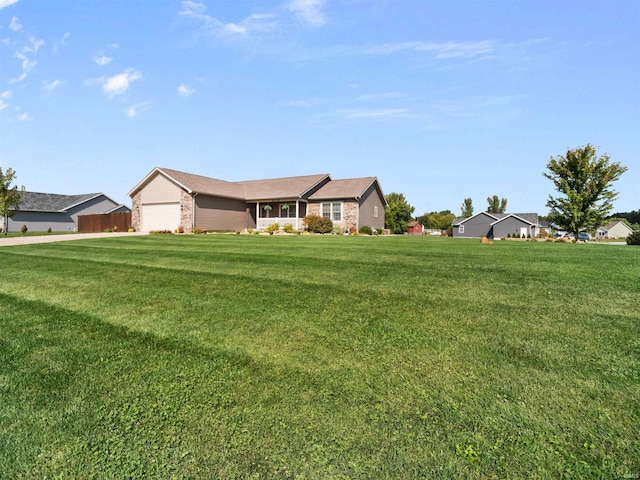 ranch-style house featuring a front yard and a garage