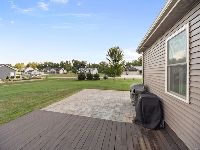 wooden deck with a yard and a patio area