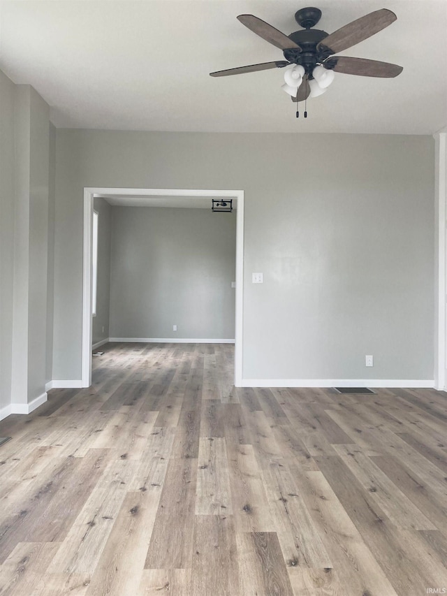 empty room featuring ceiling fan and light hardwood / wood-style flooring