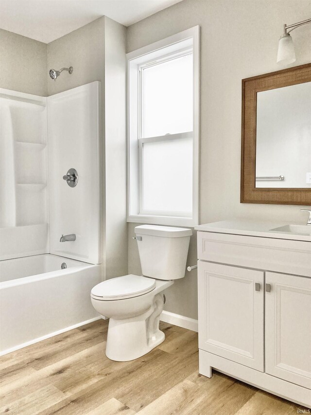 full bathroom featuring tub / shower combination, wood-type flooring, vanity, and toilet