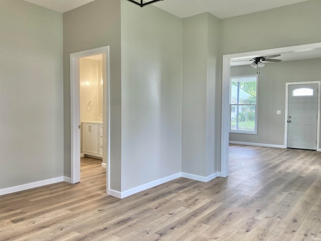 empty room with light wood-type flooring and ceiling fan