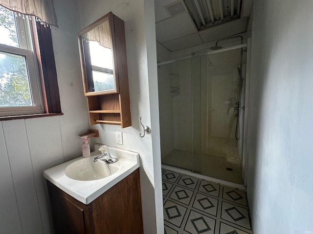 bathroom featuring vanity and a shower with shower door