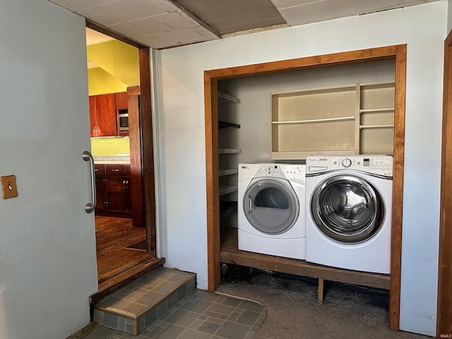 washroom with washing machine and clothes dryer