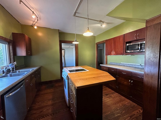 kitchen featuring a kitchen island, track lighting, appliances with stainless steel finishes, dark hardwood / wood-style floors, and wood counters