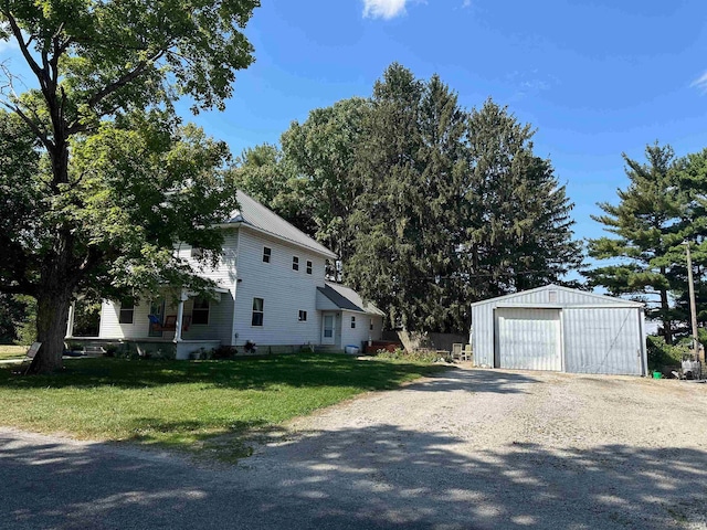 view of side of home with a lawn, an outbuilding, and a garage