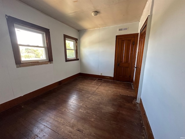 unfurnished room featuring dark hardwood / wood-style floors