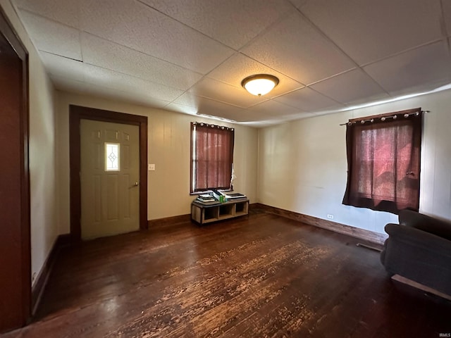 foyer entrance with a drop ceiling and dark hardwood / wood-style flooring