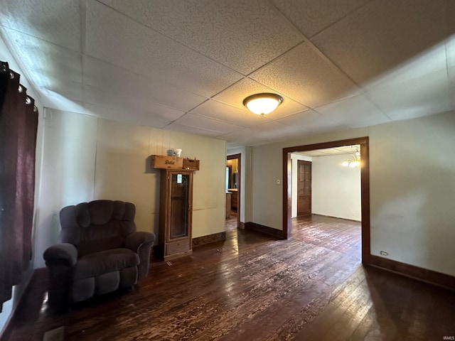 unfurnished room featuring a paneled ceiling and dark hardwood / wood-style flooring