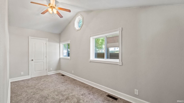 spare room with vaulted ceiling, ceiling fan, and carpet flooring