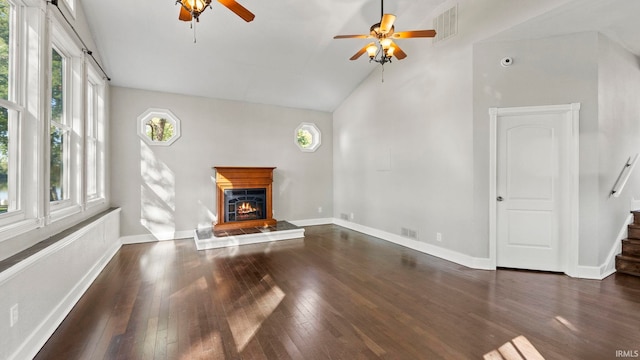 unfurnished living room featuring dark hardwood / wood-style floors, ceiling fan, and high vaulted ceiling