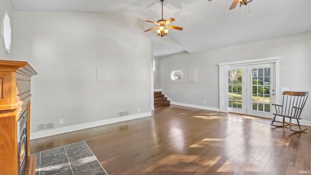 unfurnished living room featuring dark wood-type flooring, ceiling fan, and high vaulted ceiling